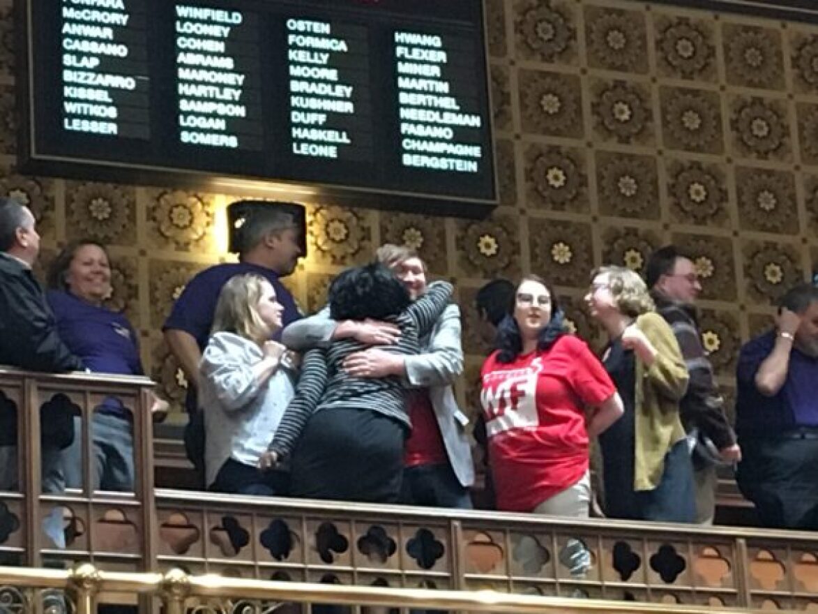 Supporters of the minimum wage celebrate in the Senate gallery after passage at nearly 3 a.m.